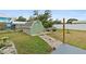 Landscaped backyard with shed and stone pathway at 705 Wayne Ave, New Smyrna Beach, FL 32168