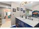 Double vanity bathroom with navy blue cabinets and marble countertop at 705 Wayne Ave, New Smyrna Beach, FL 32168