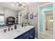 Double vanity bathroom with navy blue cabinets and marble countertop at 705 Wayne Ave, New Smyrna Beach, FL 32168