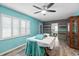 Bright dining area with wood-look floors, white table, and decorative wall at 705 Wayne Ave, New Smyrna Beach, FL 32168