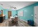 Dining area with teal walls, built-in shelving, and wood flooring at 705 Wayne Ave, New Smyrna Beach, FL 32168