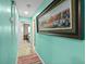 Bright hallway with light teal walls and a large framed print at 705 Wayne Ave, New Smyrna Beach, FL 32168