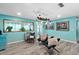 Living room with light teal walls and comfortable seating at 705 Wayne Ave, New Smyrna Beach, FL 32168