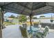 Relaxing patio with gazebo, table and chairs, and hot tub at 705 Wayne Ave, New Smyrna Beach, FL 32168