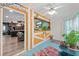 Cheerful sunroom featuring a beachy theme and kitchen peek at 705 Wayne Ave, New Smyrna Beach, FL 32168