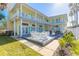 Large deck with seating area, grill, and lush landscaping at 708 Ocean Ave, New Smyrna Beach, FL 32169