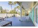 Backyard deck with rocking chairs and partial house view at 708 Ocean Ave, New Smyrna Beach, FL 32169