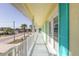 White balcony overlooking the street and palm trees at 708 Ocean Ave, New Smyrna Beach, FL 32169