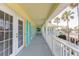 Covered balcony with gray flooring and teal shutters at 708 Ocean Ave, New Smyrna Beach, FL 32169