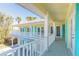 Large balcony overlooking backyard with teal shutters and white railings at 708 Ocean Ave, New Smyrna Beach, FL 32169