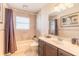 Clean bathroom with tan tile, a bathtub, and a dark brown vanity at 708 Ocean Ave, New Smyrna Beach, FL 32169