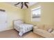 Bedroom with a queen bed, light beige walls, and a couch at 708 Ocean Ave, New Smyrna Beach, FL 32169