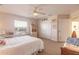 Bedroom with white bed, ceiling fan, and built-in shelving at 708 Ocean Ave, New Smyrna Beach, FL 32169