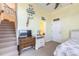 Bedroom with a sitting area, TV, and stairs nearby at 708 Ocean Ave, New Smyrna Beach, FL 32169