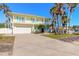 Two-story house with light yellow walls, white trim, and teal shutters at 708 Ocean Ave, New Smyrna Beach, FL 32169