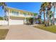 Two-story house with garage and palm trees at 708 Ocean Ave, New Smyrna Beach, FL 32169