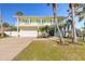 Two-story house with garage and palm trees at 708 Ocean Ave, New Smyrna Beach, FL 32169