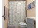 Clean bathroom with a shower/tub combo, gray vanity, and patterned curtain at 729 N Flamingo Dr, Daytona Beach, FL 32117