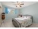 Cozy bedroom with a metal bed frame and window with curtains at 729 N Flamingo Dr, Daytona Beach, FL 32117