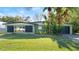 Green house exterior with black shutters, yellow chairs, and a well-maintained lawn at 729 N Flamingo Dr, Daytona Beach, FL 32117