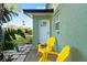 Small front patio with two yellow chairs and a view of the street at 729 N Flamingo Dr, Daytona Beach, FL 32117