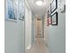 Bright hallway with framed artwork and access to bedrooms and bath at 729 N Flamingo Dr, Daytona Beach, FL 32117