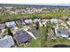 Aerial view of a neighborhood with houses and lush greenery at 813 Pine Shores Cir, New Smyrna Beach, FL 32168