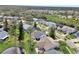 Aerial view of a house with a gray roof and a backyard near a pond at 813 Pine Shores Cir, New Smyrna Beach, FL 32168