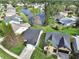 Aerial view of two houses near a lake, one with gray roof and the other with a brown roof at 813 Pine Shores Cir, New Smyrna Beach, FL 32168