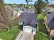 Aerial view of a house with a gray roof and a white garage door, located near a lake at 813 Pine Shores Cir, New Smyrna Beach, FL 32168