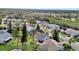 Aerial view of a house with a gray roof and a backyard near a pond at 813 Pine Shores Cir, New Smyrna Beach, FL 32168