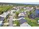 Aerial view of a residential neighborhood with houses and a lake at 813 Pine Shores Cir, New Smyrna Beach, FL 32168