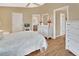 Spacious bedroom with a queen bed, wood floors, and an ensuite bathroom at 813 Pine Shores Cir, New Smyrna Beach, FL 32168