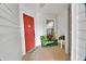 Inviting entryway with red door and potted plants at 813 Pine Shores Cir, New Smyrna Beach, FL 32168