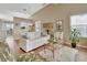 Living room with hardwood floors, white couch, and a view into the dining area at 813 Pine Shores Cir, New Smyrna Beach, FL 32168