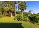 Landscaped backyard with tropical plants and lawn at 933 Meadow View Dr # D, Port Orange, FL 32127