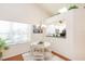 Bright dining area with white table and chairs, kitchen pass-through at 933 Meadow View Dr # D, Port Orange, FL 32127