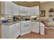 White kitchen with granite counters and ample cabinet space at 987 Mori Ct, Port Orange, FL 32127