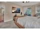 Main bedroom with a large TV and sliding door to a patio at 987 Mori Ct, Port Orange, FL 32127