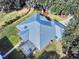 Aerial view showcasing the home's metal roof and lanai at 1004 Flying M Ct, Edgewater, FL 32132