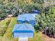 Aerial view of home with detached garage and fenced yard at 1004 Flying M Ct, Edgewater, FL 32132