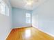 Bedroom with light blue walls and wood flooring at 1004 Flying M Ct, Edgewater, FL 32132