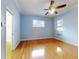 Bright bedroom with hardwood floors, ceiling fan, and ample closet space at 1004 Flying M Ct, Edgewater, FL 32132