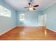 Spacious bedroom with hardwood floors, ceiling fan, and window with natural light at 1004 Flying M Ct, Edgewater, FL 32132