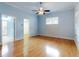 Spacious bedroom with hardwood floors, ceiling fan, and access to a walk-in closet at 1004 Flying M Ct, Edgewater, FL 32132