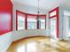 Breakfast nook with red walls, white wainscoting, and a stained glass light fixture at 1004 Flying M Ct, Edgewater, FL 32132