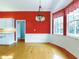 Bright breakfast nook with red walls and wood flooring at 1004 Flying M Ct, Edgewater, FL 32132