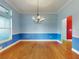 Formal dining room with hardwood floors and blue walls at 1004 Flying M Ct, Edgewater, FL 32132