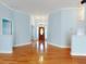 Light and airy entryway with hardwood floors and a charming wooden front door at 1004 Flying M Ct, Edgewater, FL 32132