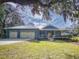 Home with three-car garage and landscaped yard at 1004 Flying M Ct, Edgewater, FL 32132